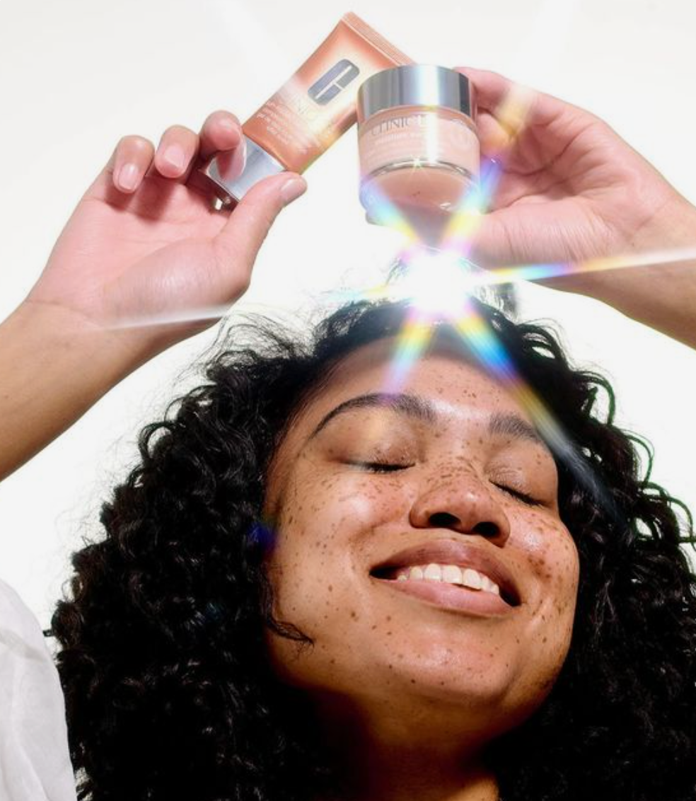 women holding products above her head with a reflecting light